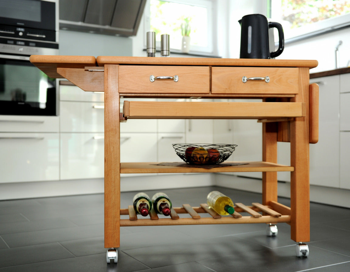 Küchenwagen Mobil 2 aus massiver Buche. Basismodell 90 x 50x 81 cm mit Seitenklappen (breite x Tiefe x Höhe) mit 2 Schubladen, einem Boden und Flaschenablage, Seitenklappen und Tablett zum ausklappen auf 140cm Breite